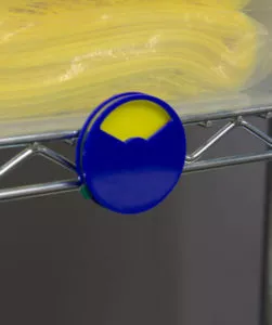 Blue plastic indicator dial with indicator on yellow attached to metal supply shelf | Maxpert Medical